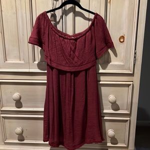 Off the shoulder dress in a rust color with fringe at the bottom.  size m/l